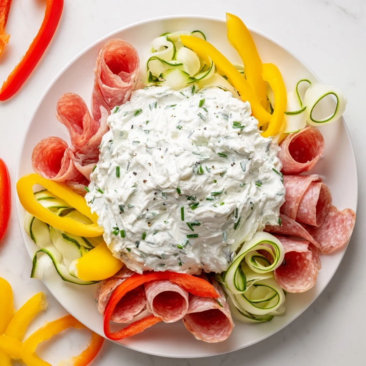 The Medusa Curls: a party-ready platter with radiating meat spirals and creamy dip head.