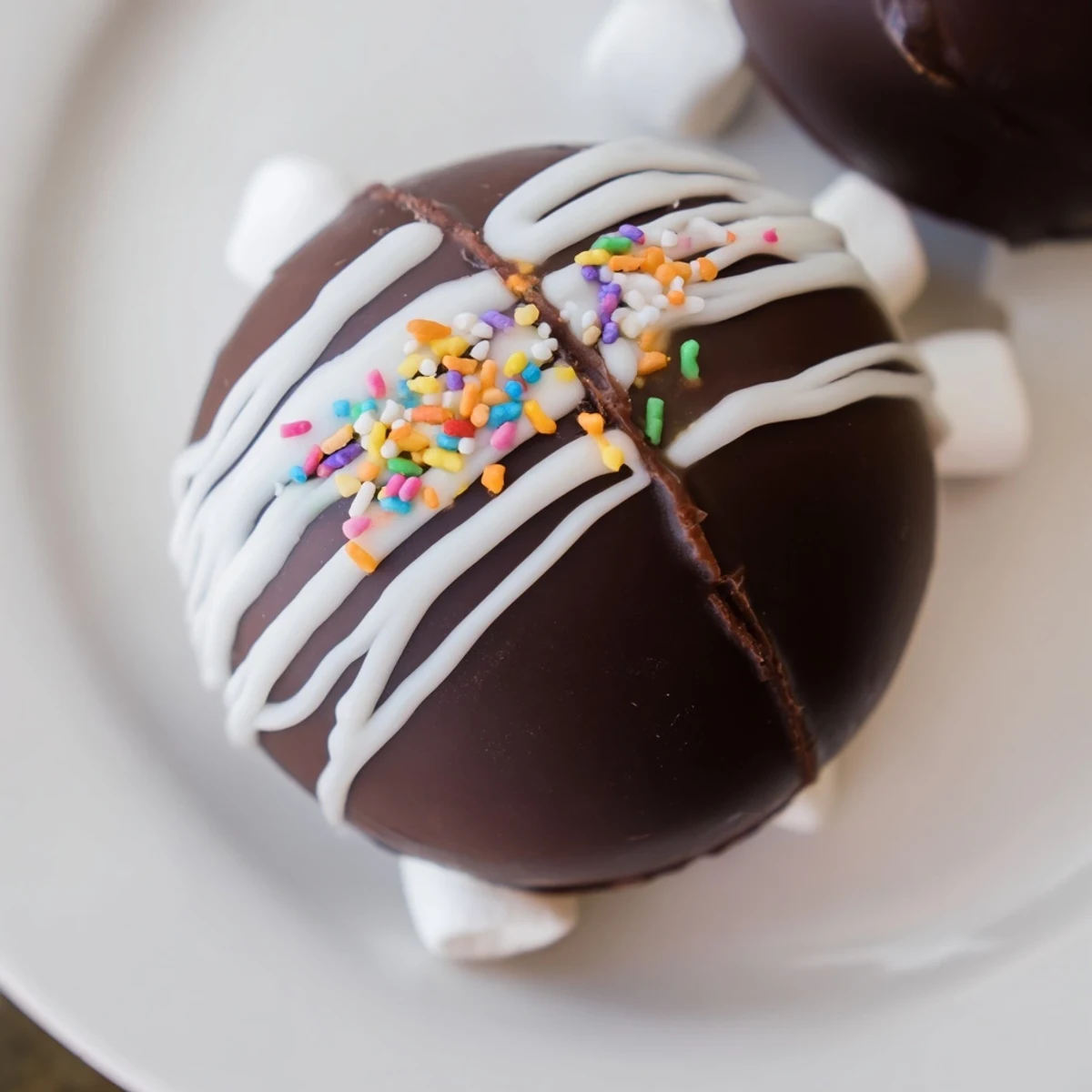 A close-up view of Hot Chocolate Bombs featuring decorative sprinkles and a rich cocoa filling inside.