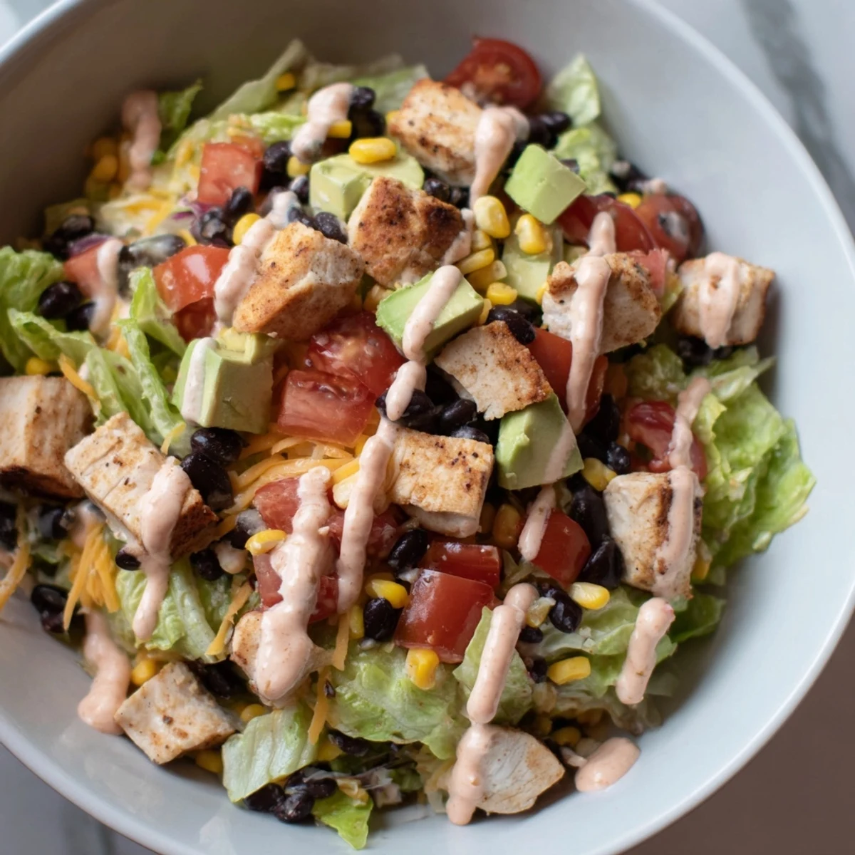 Hearty Chicken Taco Chopped Salad features juicy chicken, crisp lettuce, black beans, and fresh avocado.  