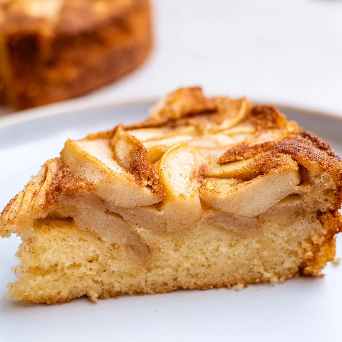 Freshly baked Baked Apple Cake, golden crust with tender apples, served warm from the oven.