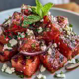 Grilled watermelon salad with feta and mint, juicy watermelon wedges caramelized on the grill and topped with creamy cheese.