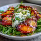 Grilled peach wedges and burrata cheese atop mixed greens, finished with a sweet honey and balsamic glaze.