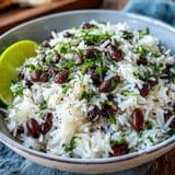 Fluffy Coconut Lime Rice with beans and cilantro, perfect for a quick weeknight meal.