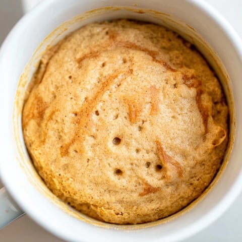 Warm 2-Minute Peanut Butter Mug Cake, a quick dessert with a light, fluffy texture and rich flavor.