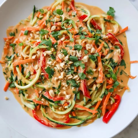 Vibrant Zesty Peanut Zucchini Noodles, a colorful salad with peanuts and fresh cilantro.