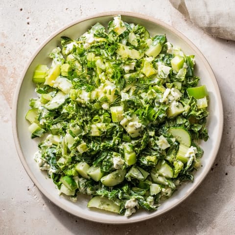 A bowl of fresh Green Goddess Cabbage Dip, ready to scoop up with crunchy tortilla chips for serving.