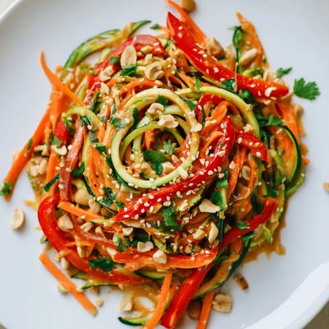 Creamy peanut sauce coats the zucchini noodles in this delicious Zesty Peanut Zucchini Noodles recipe.