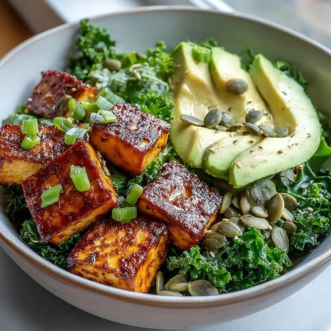Protein-packed tofu breakfast bowl featuring crispy spiced tofu, wilted kale, and fresh avocado, perfect for a healthy morning meal.