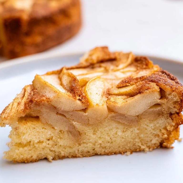 Freshly baked Baked Apple Cake, golden crust with tender apples, served warm from the oven.