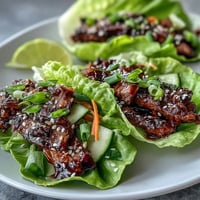 Juicy Korean BBQ beef nestled in crisp lettuce with bright, spicy kimchi.